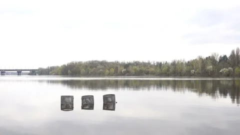4K view of the river overflow and flooded trash cans Stock Footage 241610887