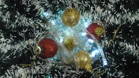 4K view of rolled up Christmas tree branches with garland Stock Footage 142558750