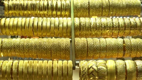4K view of the rows of gold bracelets as a background Stock Footage 127057130