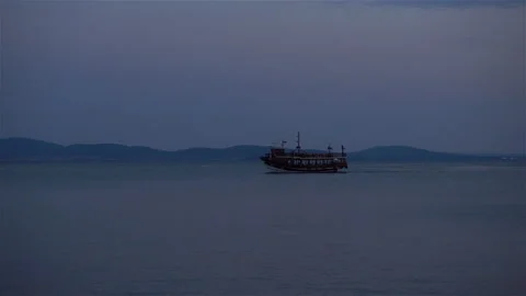 4K view of the silhouette of the ship in the dark evening sea and sky Stock Footage 114294381
