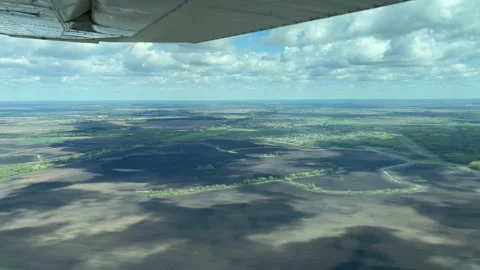 4K View from small plane from wing side on clouds and land Stock Footage 155805964