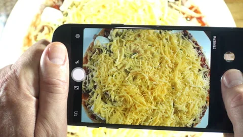 4K view of a smartphone taking pizza photos. Stock Footage 133227494