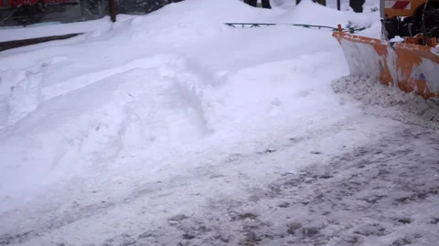 4K view of snow-cleaning machine cleans the street Stock Footage 86597136