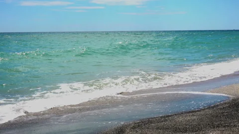 4K view of soft sea waves passes through a sandy beach. Stock Footage 93159173