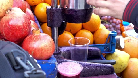 4K view of squeezing the juice from fresh pomegranate fruit Stock Footage 86085217