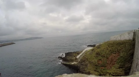 4K View of stone staircase from a building leading down to the sea, cloudy sky Stock Footage 45664872