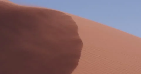 4K view of strong wind blowing sand off the edge of the dune Stock Footage 64697074