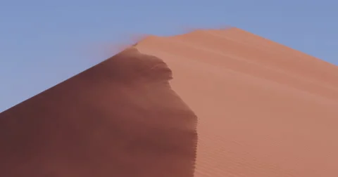 4K view of strong wind blowing sand off the edge of the dune Stock Footage 64697096