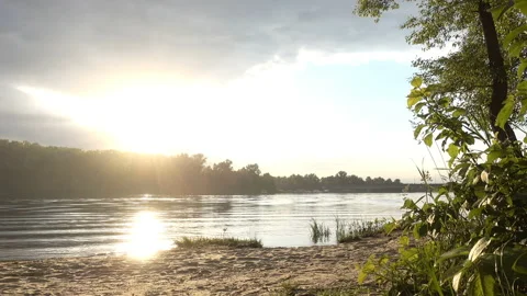 4K view of a sunset in a cloudy sky over a river and forest. Stock Footage 233724921