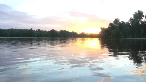 4K view of sunset over a river and forest. Stock Footage 233724082