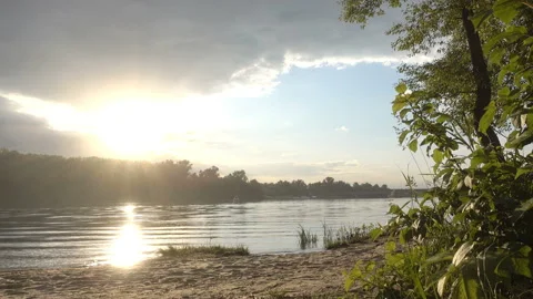 4K view of a sunset on a river in a forest in a cloudy sky. Stock Footage 187524992