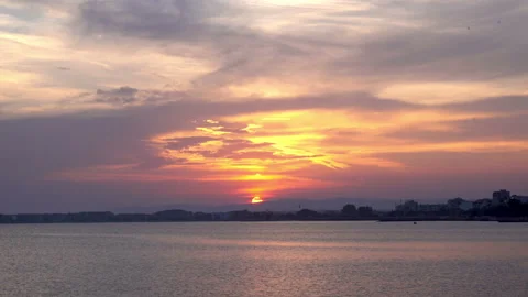 4K view of sunset on the seashore against the backdrop of the cityscape. Stock Footage 92819286