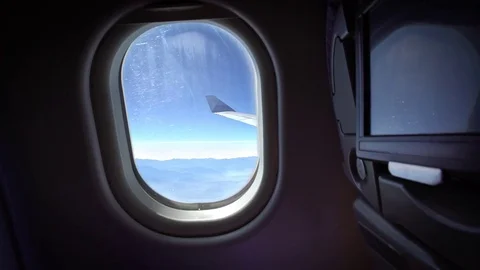 4K View Through An Airplane Window, Winter Mountains From The Plane Window-Dan Stock Footage 76966641
