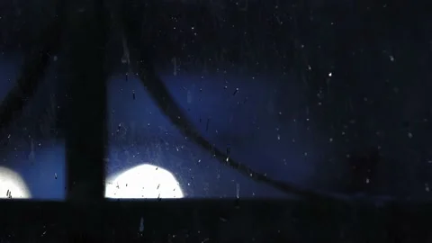4K View through glass with raindrops, car headlights shine in bokeh Stock Footage 196488027