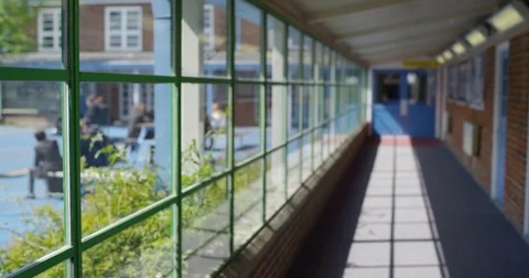 4K View through school window of children enjoying break time outdoors Stock Footage