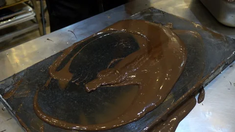 4k view of warm chocolate poured and formed with a spatula Stock Footage 112921478