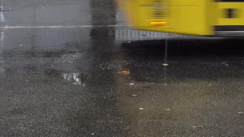 4K view of the wheels of a bus driving through puddles Stock Footage 138792863