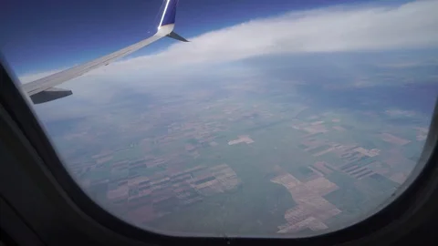 4k View of the wing and the clouds from the plane window. Beautiful sunny day. Stock Footage 122937321