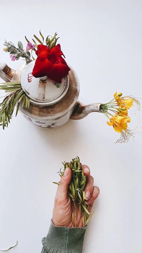 4K Vintage Rustic Teapot with Red and Yellow Floral Blossoms Stock-Footage 339275330