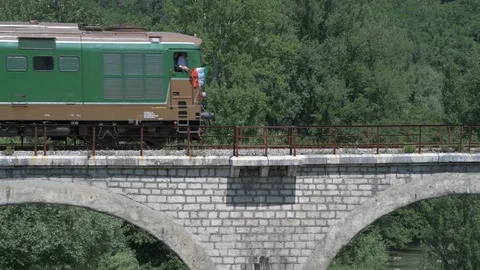 4K vintage train crossing an old brick arch bridge Stock Footage 90806295