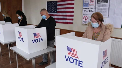 4K: Voters voting for the USA Presidential Election with Face Masks. Covid-19 Stock Footage