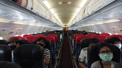 4K Walk through passengers wear surgical mask inside Thai Air Asia airplane Stock Footage 145202018