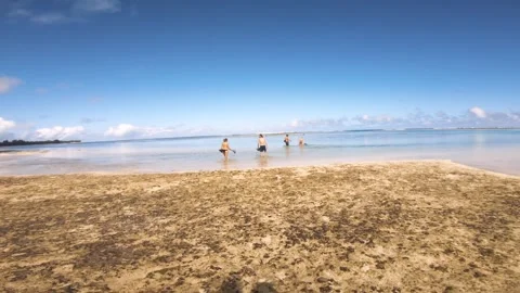 4k walking into Avaavaroa sandy beach atoll lagoon during good weather blue sky  Stock Footage 250472197