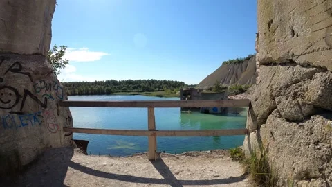 4k walking on a balcony with a scenic view to abandoned prison in Rummu Quarry Stock Footage 157012964
