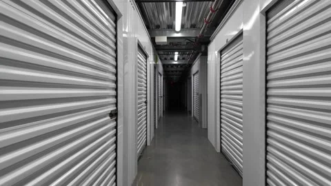 4K walking footage inside modern self storage facility corridor in the  USA  Vídeo Stock 333571645