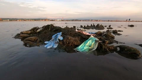 4K, Waste during COVID19. Discarded ocean coronavirus face masks. Pollution -Dan Stock Footage 134281786