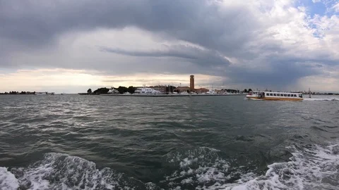 4K. Water bus or public transport boat sailing near a harbor in Venice, Italy. Stock Footage 105260377