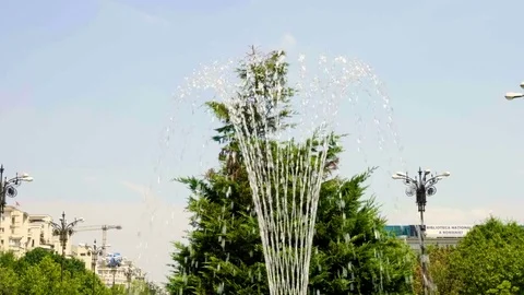 4k Water drops from fountain in city splashing on water surface in slow motion Stock Footage