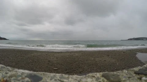 4K water rolling in on beach a clouded autumn day in the british isles Stock Footage 47373768