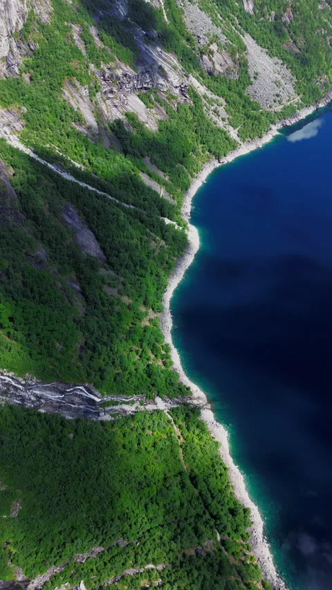 4K Waterfall Cascading from Cliffs into Serene Landscape, Trolltunga, Norway Stock Footage 296021822
