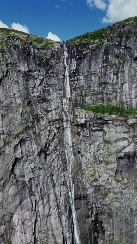 4K Waterfall Cascading Down Rocky Cliffs in a Natural Paradise, Norway, Portrait Stock Footage 296021351