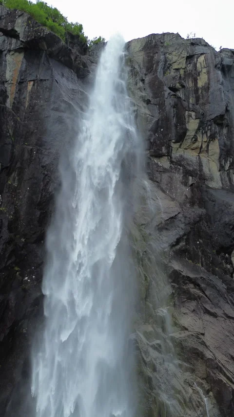 4K waterfall cascading down rocky cliffs in Norway, Portrait Orientation Stock Footage 296027487