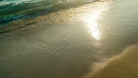 4k waves on beach at sunset time , sunlight reflect on water surface Stock Footage 107750977