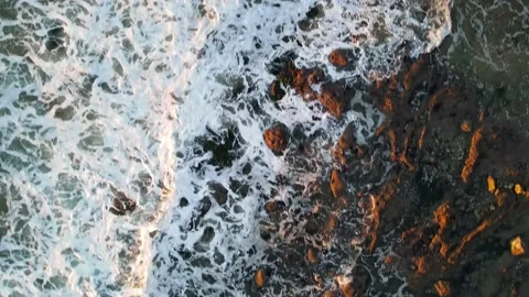 4K Waves crashing into rocks during sunset Stock Footage 145448678