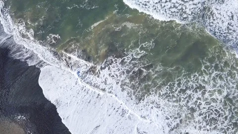 4K Waves foaming in shallow water and rolling onto the beach Stock Footage 115508355