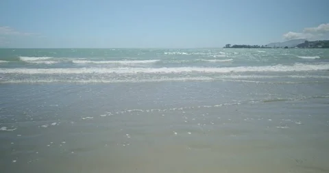 4K - Waves lap at white Sandy Beach. Stock Footage 225434350