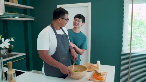 4K, While this man was standing in the kitchen cooking breakfast Stock Footage 197811976