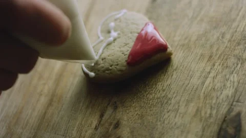 4K White Icing Outlining a Santa-shaped Gingerbread Cookie Stock Footage 342113589
