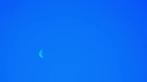 4K. White Moon moves in a clear blue sky. Time-lapse. Stock Footage 61089251