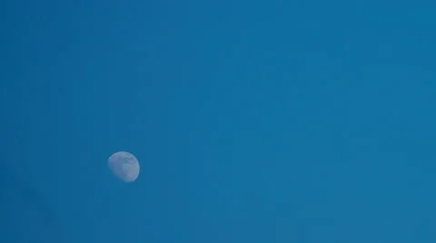 4K. White Moon moves in a clear blue sky. Time-lapse. Stock Footage 61089626