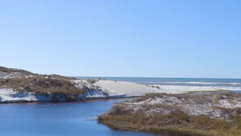 4K White Sandy Dune Surrounded Lake Feeding into the Ocean Stock Footage 109373396