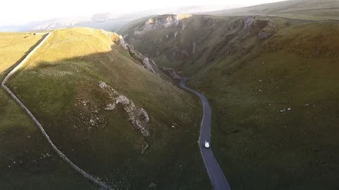 4k White van aerial tracking shot at sunset through beautiful valley Stock Footage 105864580