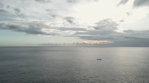4K Wide aerial view of small boat on the sea between clouds Stockbeeldmateriaal 277375246