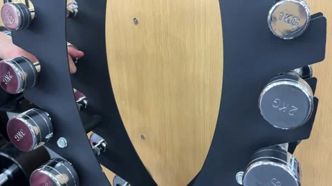 4K Wide Angle of Hand Lifting 2kg Weight from Fitness Rack Stock Footage 329336471