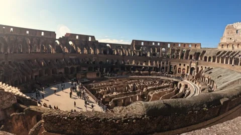 4k wide angle view inside the colosseum with tourists down the bottom exploring Stock Footage 235623041