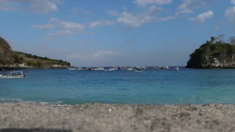 4K wide angle view over a remote pretty lagoon with tourism boats in Bali Stock Footage 136337408